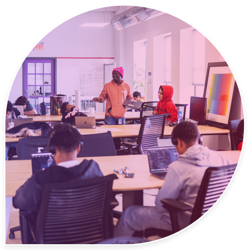 dae instructors and students in classroom working on computers